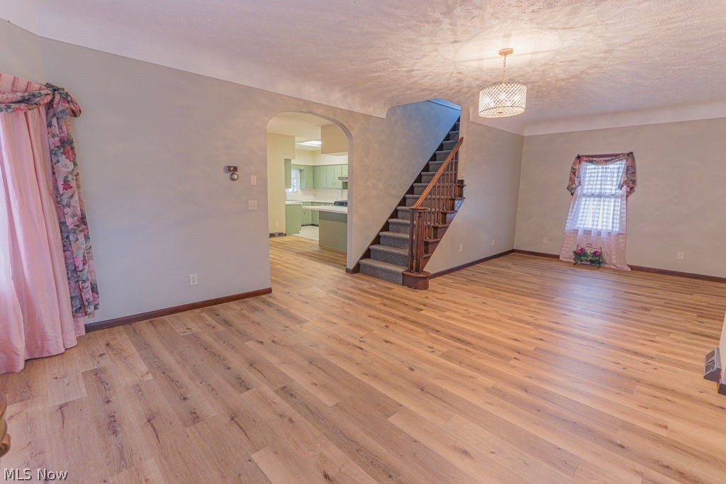 51883 Telegraph Road Amherst, OH 44001 - Photo 21 of 49 Unfurnished room featuring light hardwood / wood-style floors and a textured ceiling