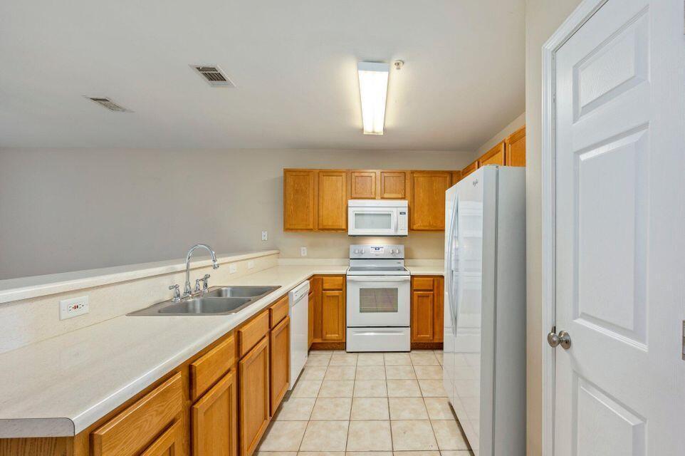 17 Southeast Shell Avenue, Unit B2 Fort Walton Beach, FL 32548 - Photo 3 of 8 a kitchen with a sink cabinets stainless steel appliances and a window