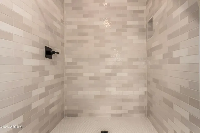 a bathroom with a double vanity sink a mirror and a shower