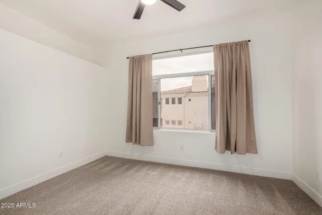 an empty room with a empty space and windows