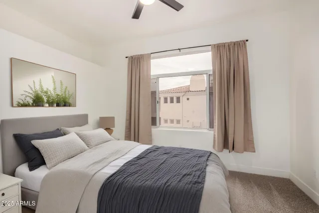 a bedroom with a bed and a window