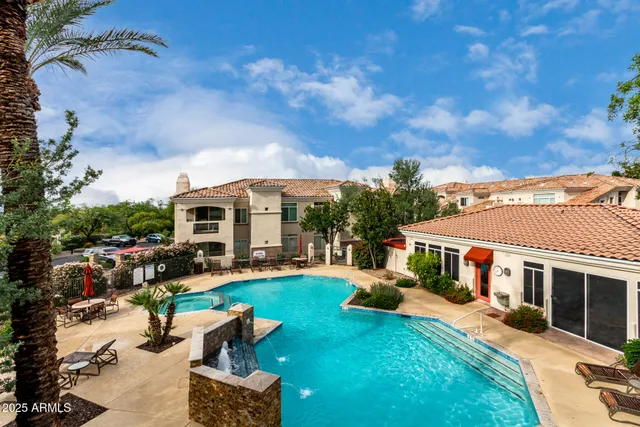 a view of a white house with a yard