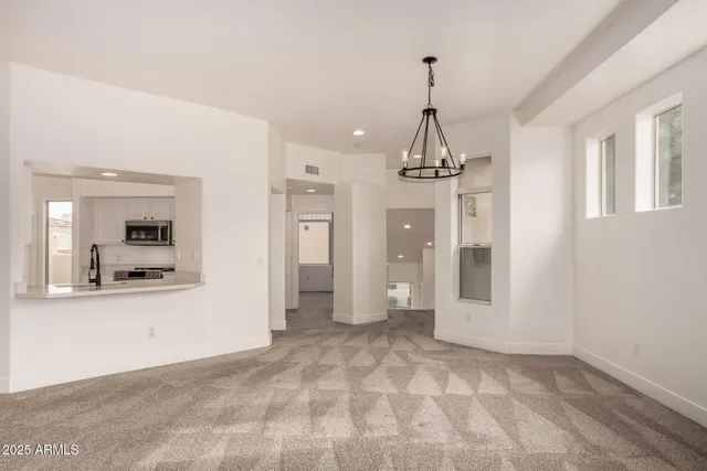 a view of empty room with a fireplace and fan