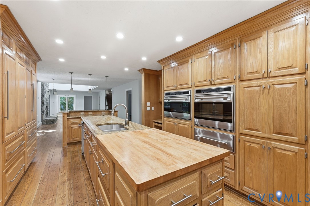 3201 East Brigstock Road Midlothian, VA 23113 - Photo 12 of 72 a kitchen with kitchen island wooden cabinets and stainless steel appliances