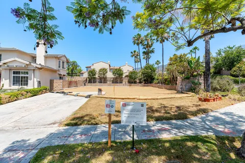 a view of a swimming pool with a lawn chairs and a potted plants