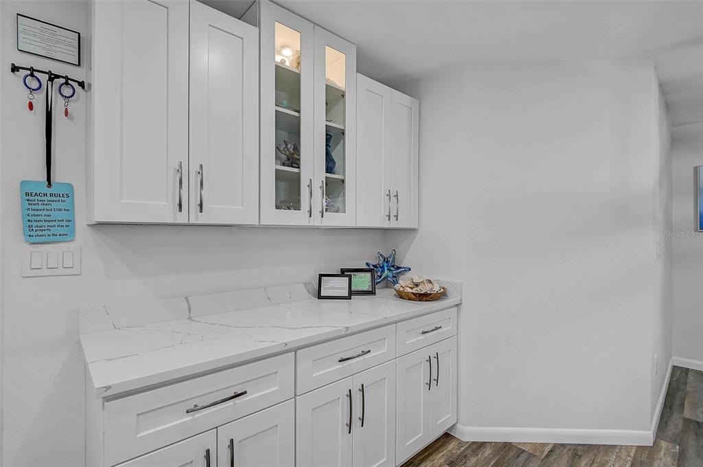6308 Midnight Pass Road, Unit 6 Sarasota, FL 34242 - Photo 11 of 44 a kitchen with stainless steel appliances granite countertop white cabinets and a sink