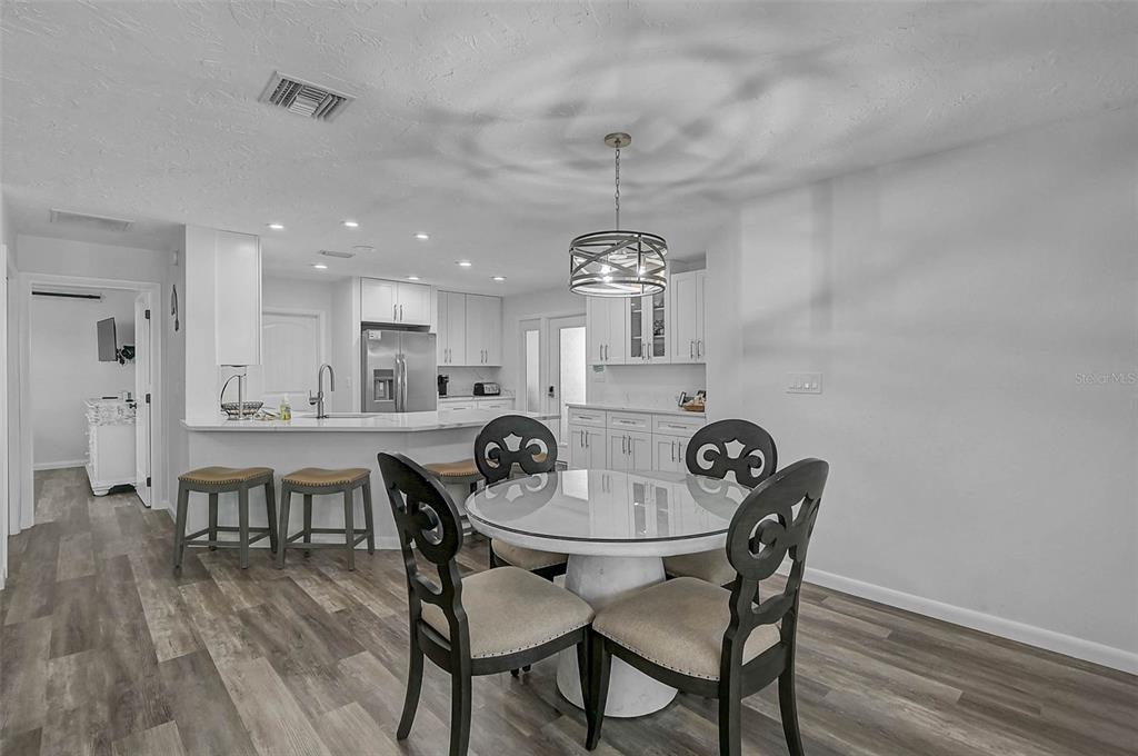 6308 Midnight Pass Road, Unit 6 Sarasota, FL 34242 - Photo 13 of 44 a view of a dining room with furniture and wooden floor