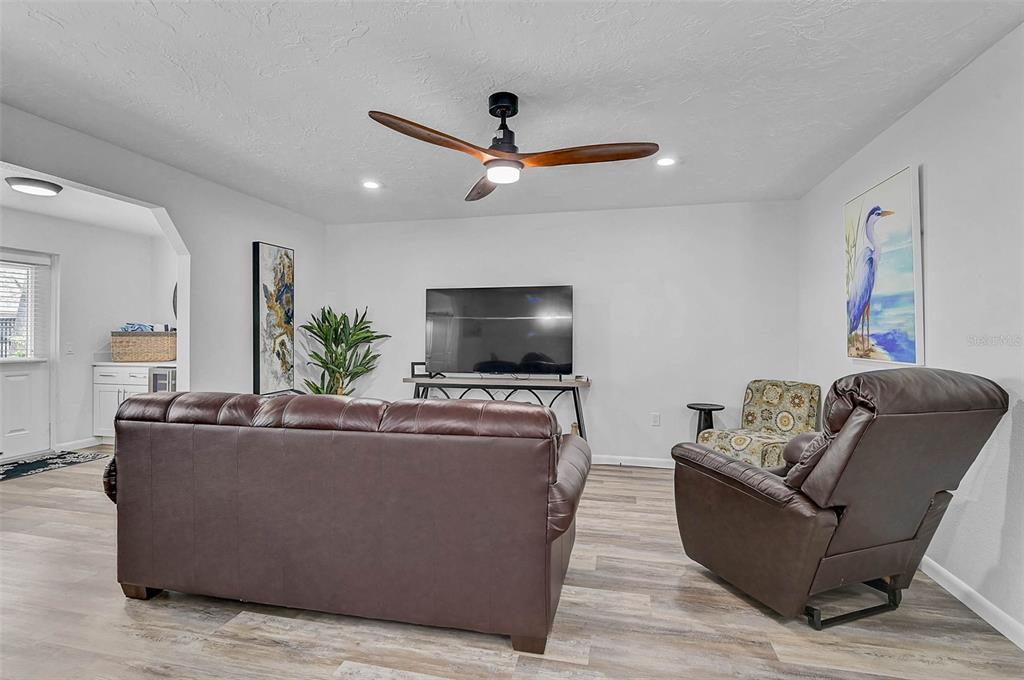 6308 Midnight Pass Road, Unit 6 Sarasota, FL 34242 - Photo 15 of 44 a living room with furniture and a flat screen tv