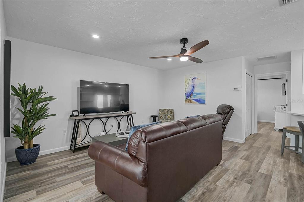 6308 Midnight Pass Road, Unit 6 Sarasota, FL 34242 - Photo 16 of 44 a living room with furniture and a flat screen tv