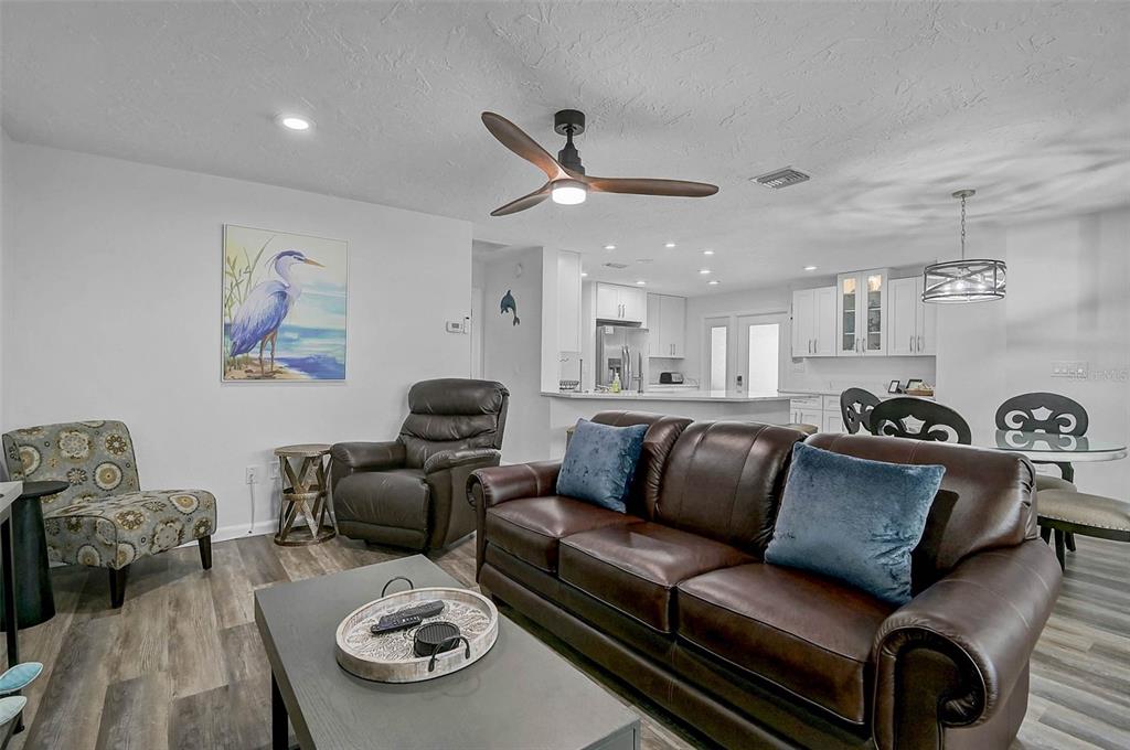 6308 Midnight Pass Road, Unit 6 Sarasota, FL 34242 - Photo 17 of 44 a living room with furniture ceiling fan and a rug