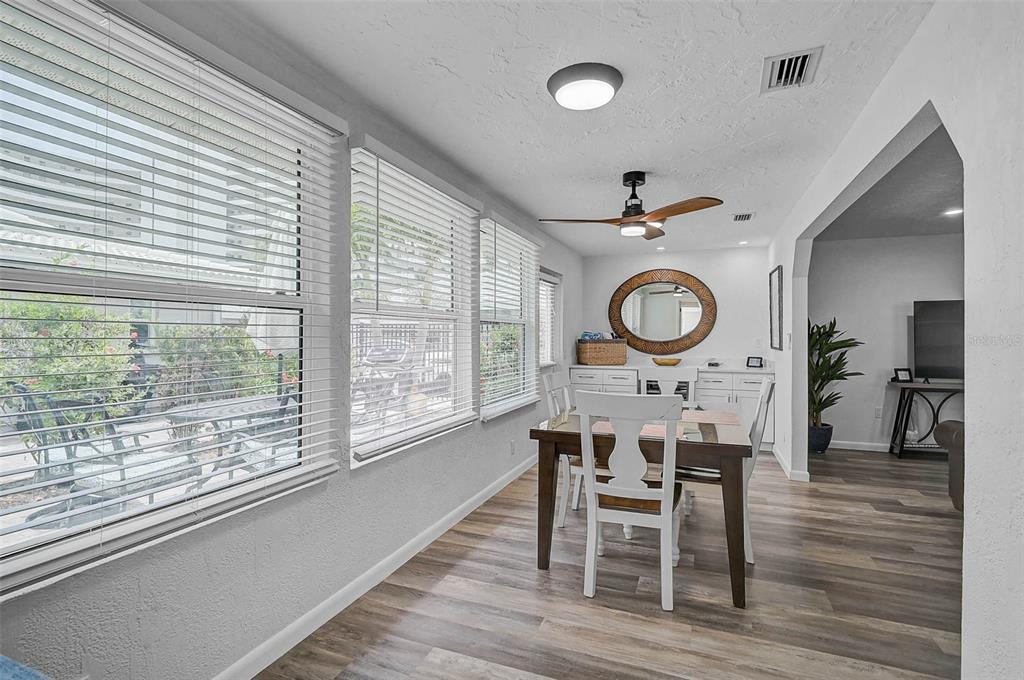 6308 Midnight Pass Road, Unit 6 Sarasota, FL 34242 - Photo 19 of 44 a view of a dining room with furniture window and wooden floor
