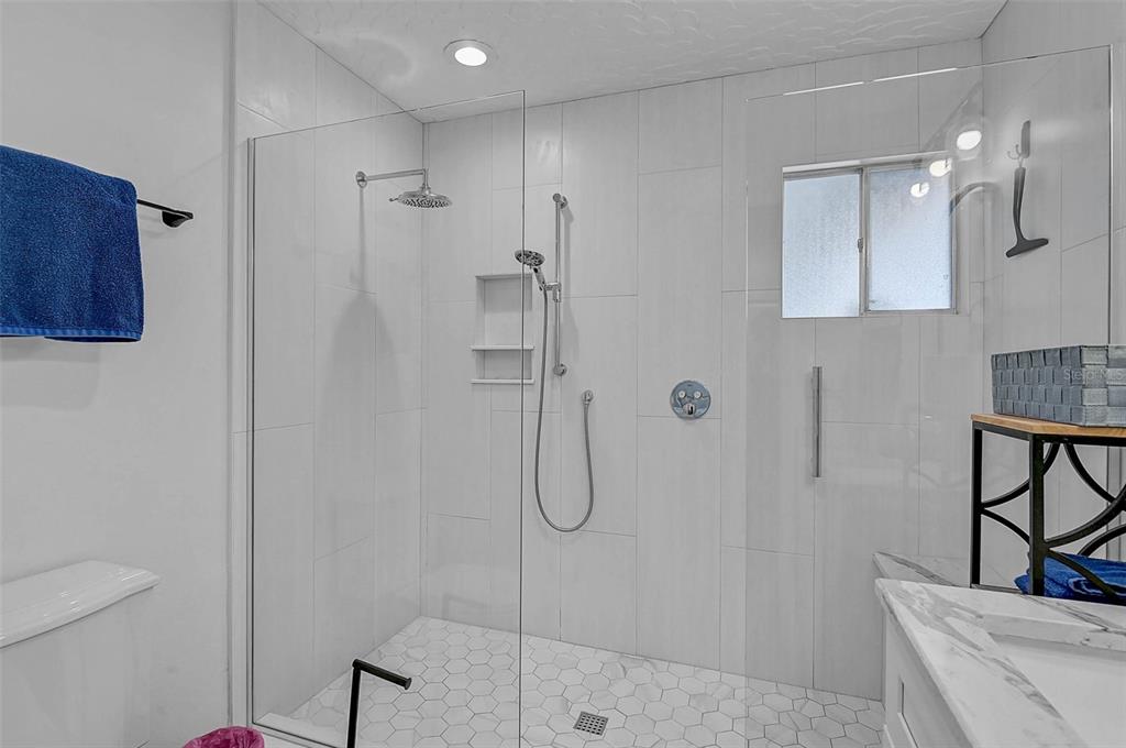 6308 Midnight Pass Road, Unit 6 Sarasota, FL 34242 - Photo 22 of 44 a bathroom with a shower a toilet and sink