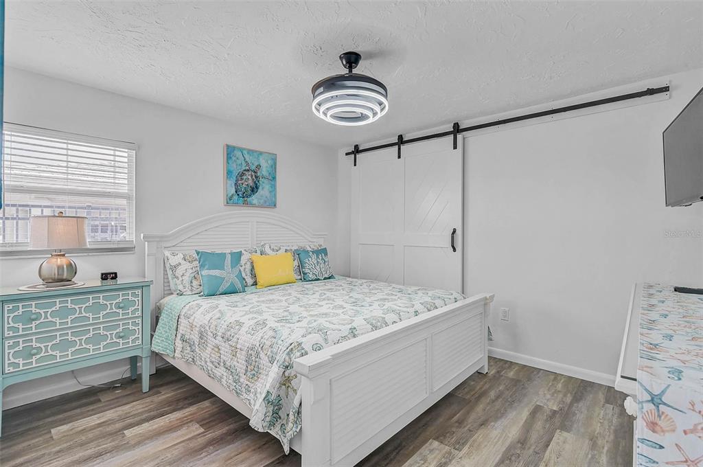 6308 Midnight Pass Road, Unit 6 Sarasota, FL 34242 - Photo 23 of 44 a bedroom with a bed and a window