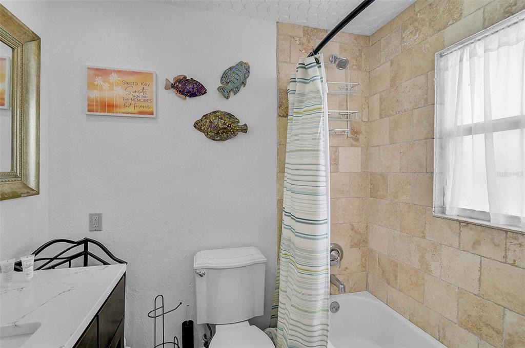 6308 Midnight Pass Road, Unit 6 Sarasota, FL 34242 - Photo 24 of 44 a bathroom with a sink toilet and shower