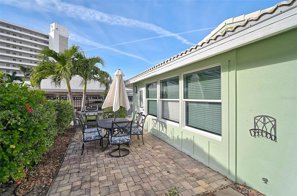 6308 Midnight Pass Road, Unit 6 Sarasota, FL 34242 - Photo 29 of 44 a view of a patio with table and chairs and potted plants