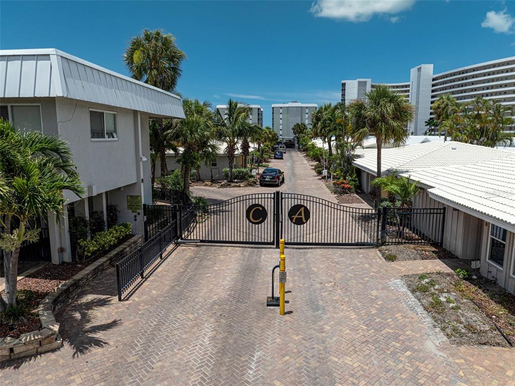 6308 Midnight Pass Road, Unit 6 Sarasota, FL 34242 - Photo 33 of 44 a view of backyard with a table and chairs and potted plants