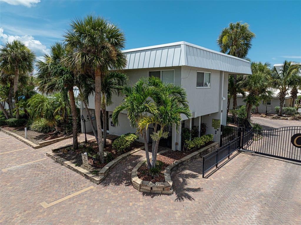 6308 Midnight Pass Road, Unit 6 Sarasota, FL 34242 - Photo 34 of 44 a front view of a house with garden