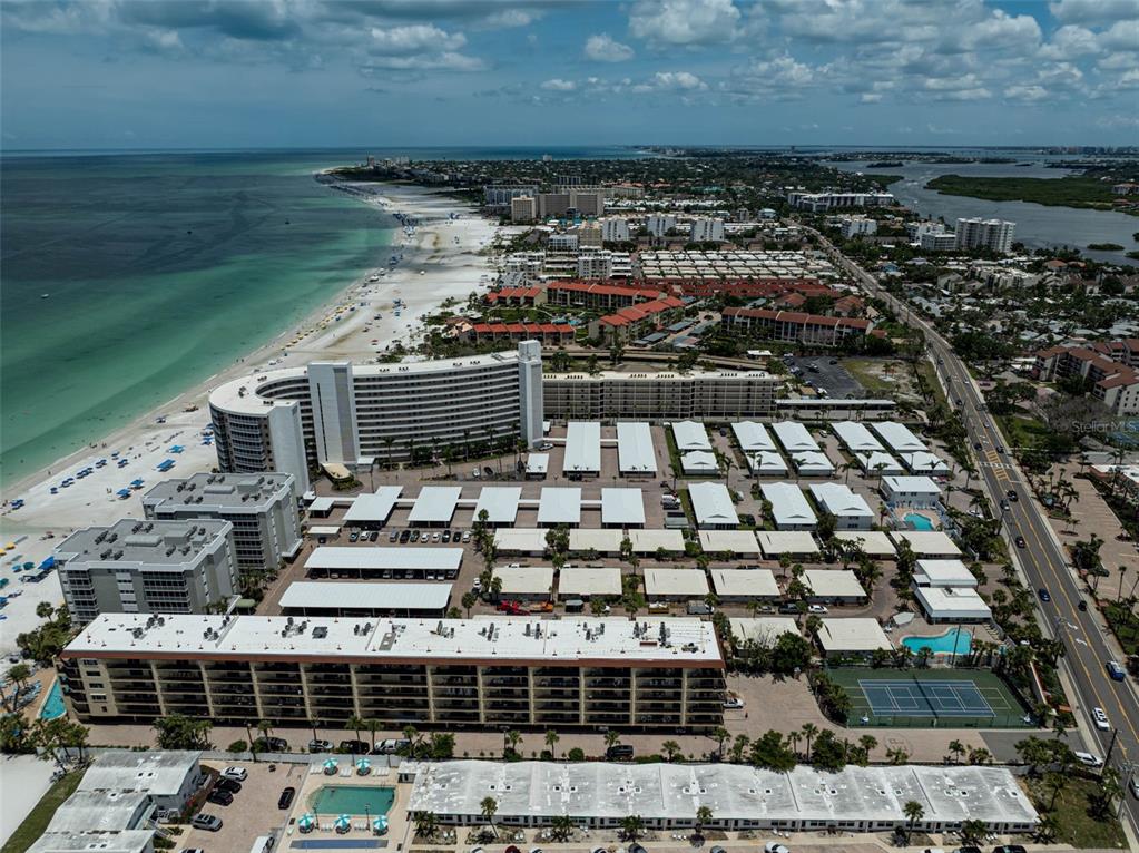 6308 Midnight Pass Road, Unit 6 Sarasota, FL 34242 - Photo 41 of 44 a view of building with yard and ocean view