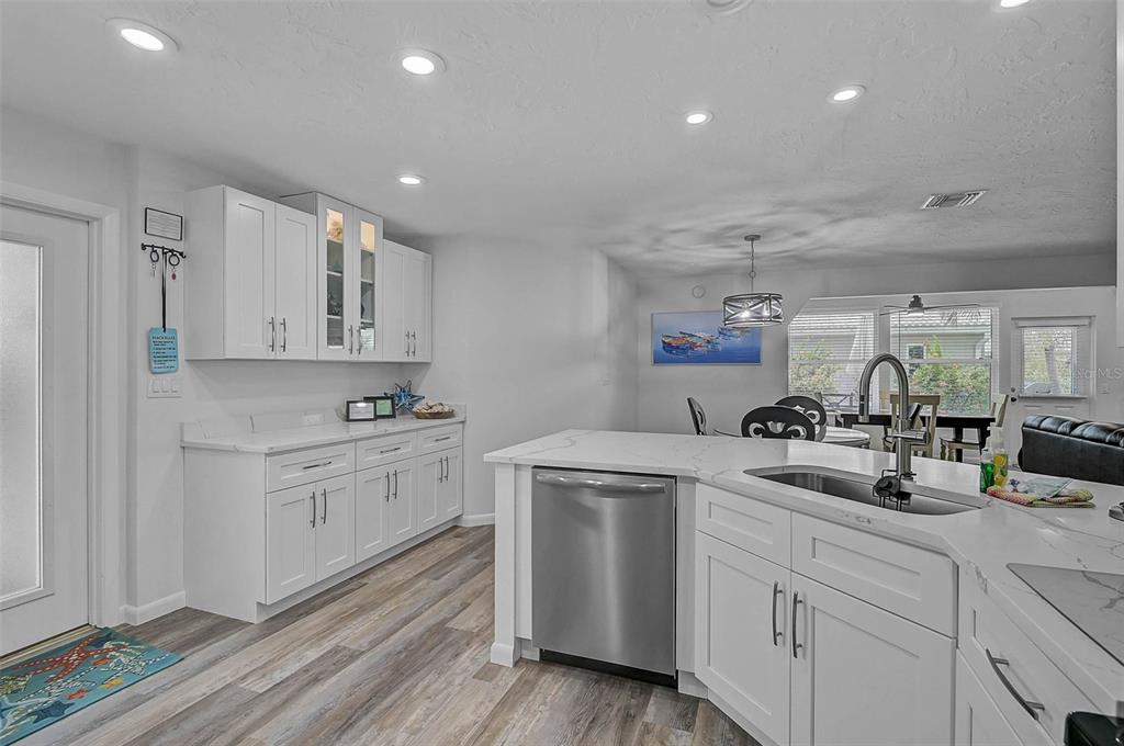 6308 Midnight Pass Road, Unit 6 Sarasota, FL 34242 - Photo 10 of 44 a kitchen with white cabinets appliances and sink