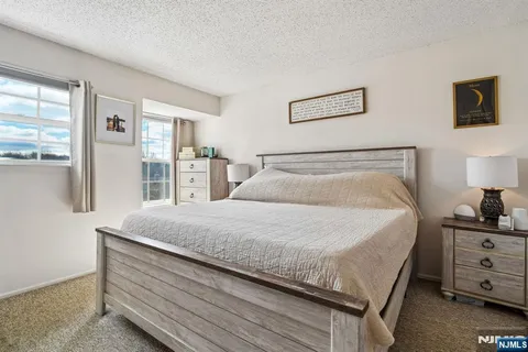a bedroom with a bed and large window