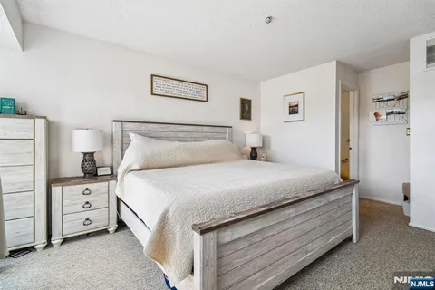 a bedroom with a bed and a cabinets