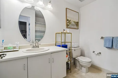 a bathroom with a toilet sink and mirror