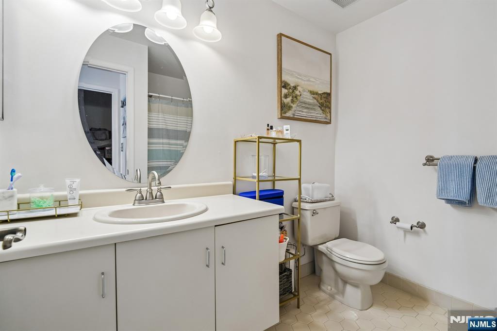 1317 Paddington Road Mahwah, NJ 07430 - Photo 16 of 28 a bathroom with a toilet sink and mirror