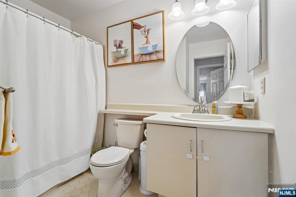 1317 Paddington Road Mahwah, NJ 07430 - Photo 17 of 28 a bathroom with a toilet a sink and a mirror
