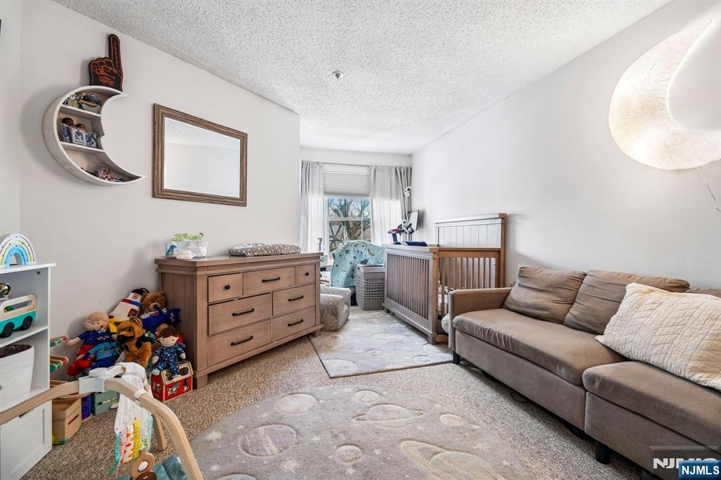 1317 Paddington Road Mahwah, NJ 07430 - Photo 19 of 28 a bedroom with furniture and a wooden floor