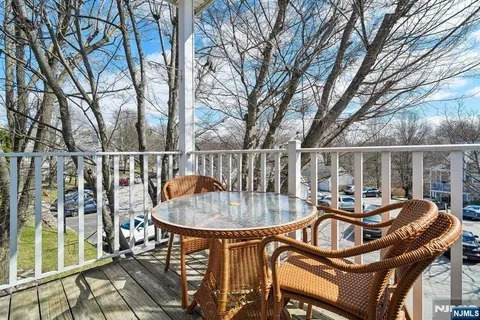 a backyard of a house with barbeque oven table and chairs