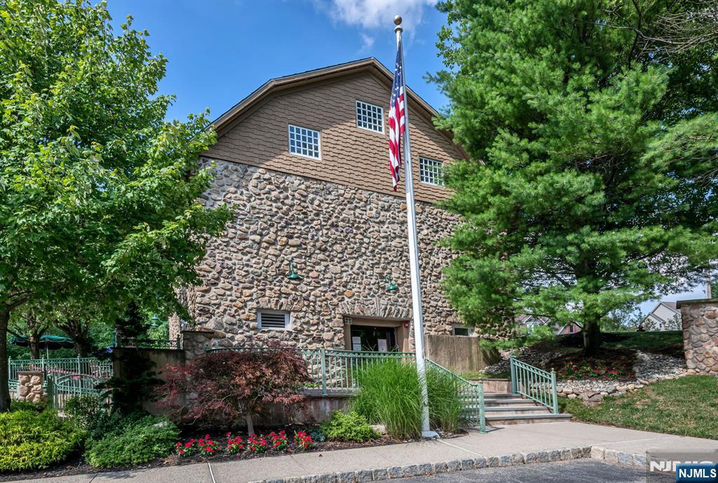 1317 Paddington Road Mahwah, NJ 07430 - Photo 23 of 28 a front view of a house with a garden