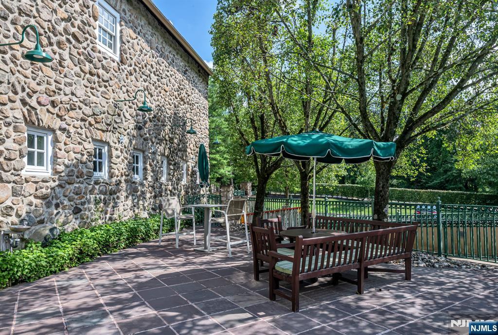 1317 Paddington Road Mahwah, NJ 07430 - Photo 24 of 28 a view of a patio with a table and chairs