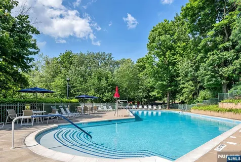 a view of a swimming pool with chairs