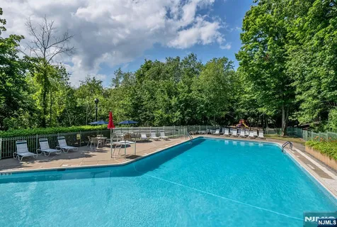 a swimming pool with outdoor seating and yard