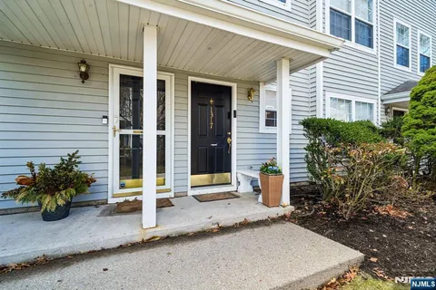 a front view of a house with outdoor seating