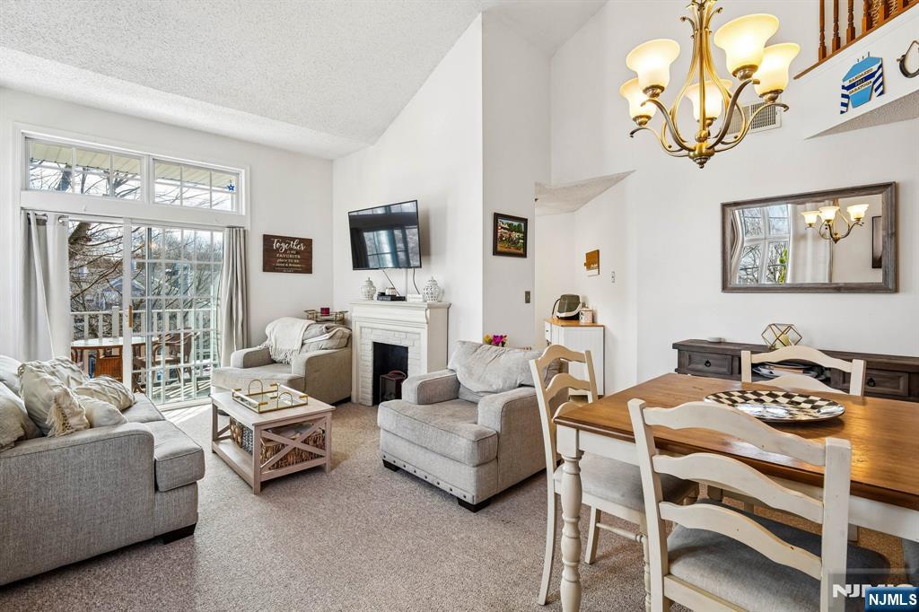 1317 Paddington Road Mahwah, NJ 07430 - Photo 4 of 28 a living room with furniture a fireplace and a large window