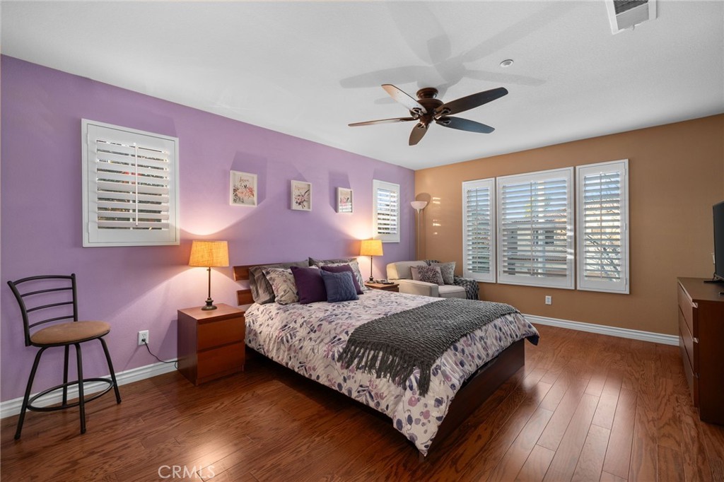 4140 Garvey Way Riverside, CA 92501 - Photo 11 of 25 a bedroom with a bed a chair and a large window