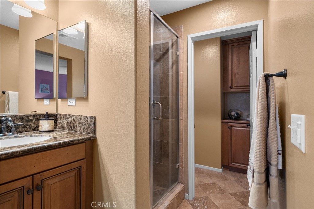 4140 Garvey Way Riverside, CA 92501 - Photo 14 of 25 a bathroom with a granite countertop sink and a mirror