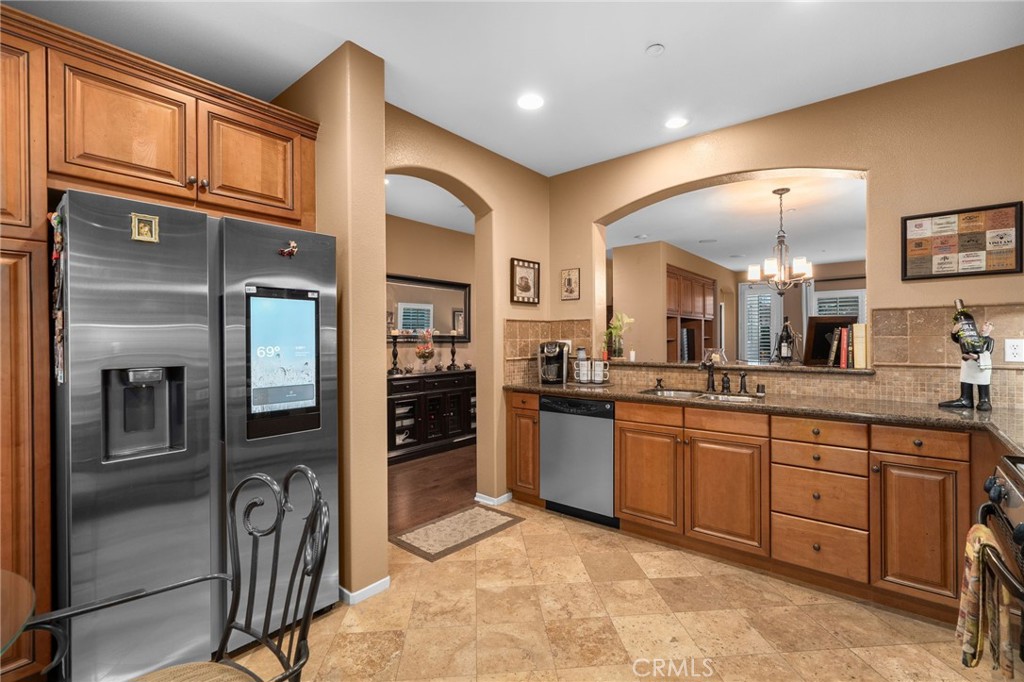4140 Garvey Way Riverside, CA 92501 - Photo 7 of 25 a kitchen with stainless steel appliances granite countertop a refrigerator and cabinets