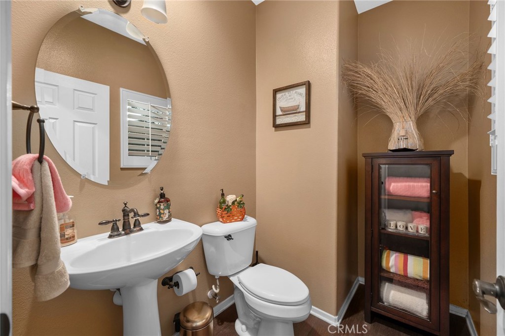 4140 Garvey Way Riverside, CA 92501 - Photo 9 of 25 a bathroom with a toilet sink and mirror