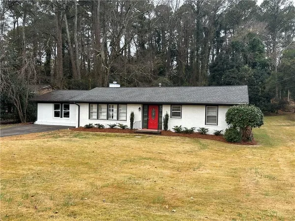 a view of pool with lawn chairs and large trees