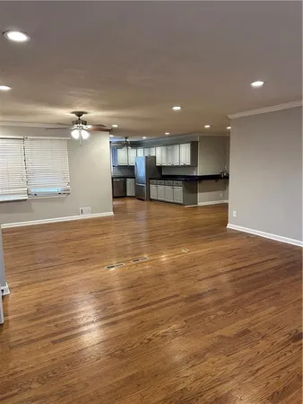 a large kitchen with granite countertop a stove and cabinets