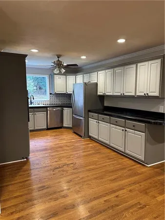 a large kitchen with kitchen island granite countertop a stove and a sink