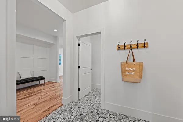 a view of a hallway with the glass door and couch