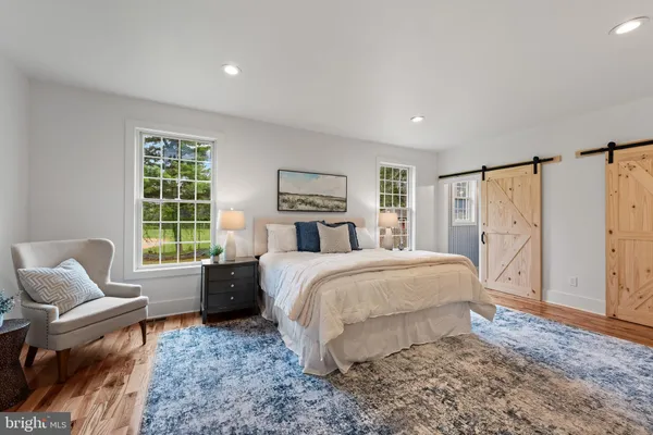 a bed room with a bed and a chair