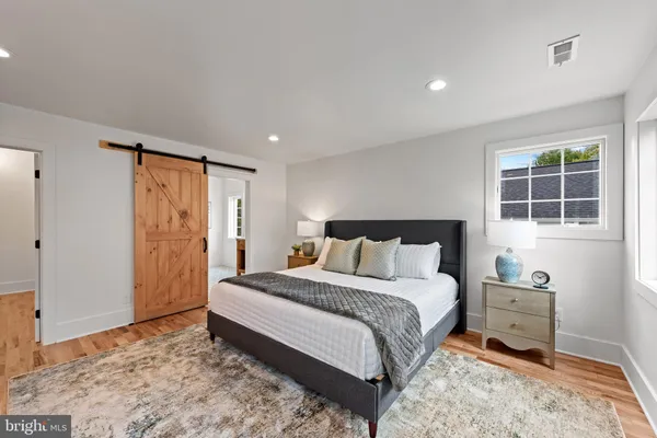 a spacious bedroom with a bed and a window