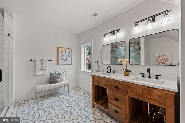 a spacious bathroom with a double vanity sink mirror and toilet