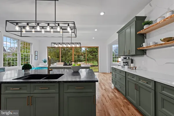 a kitchen with a sink and large windows