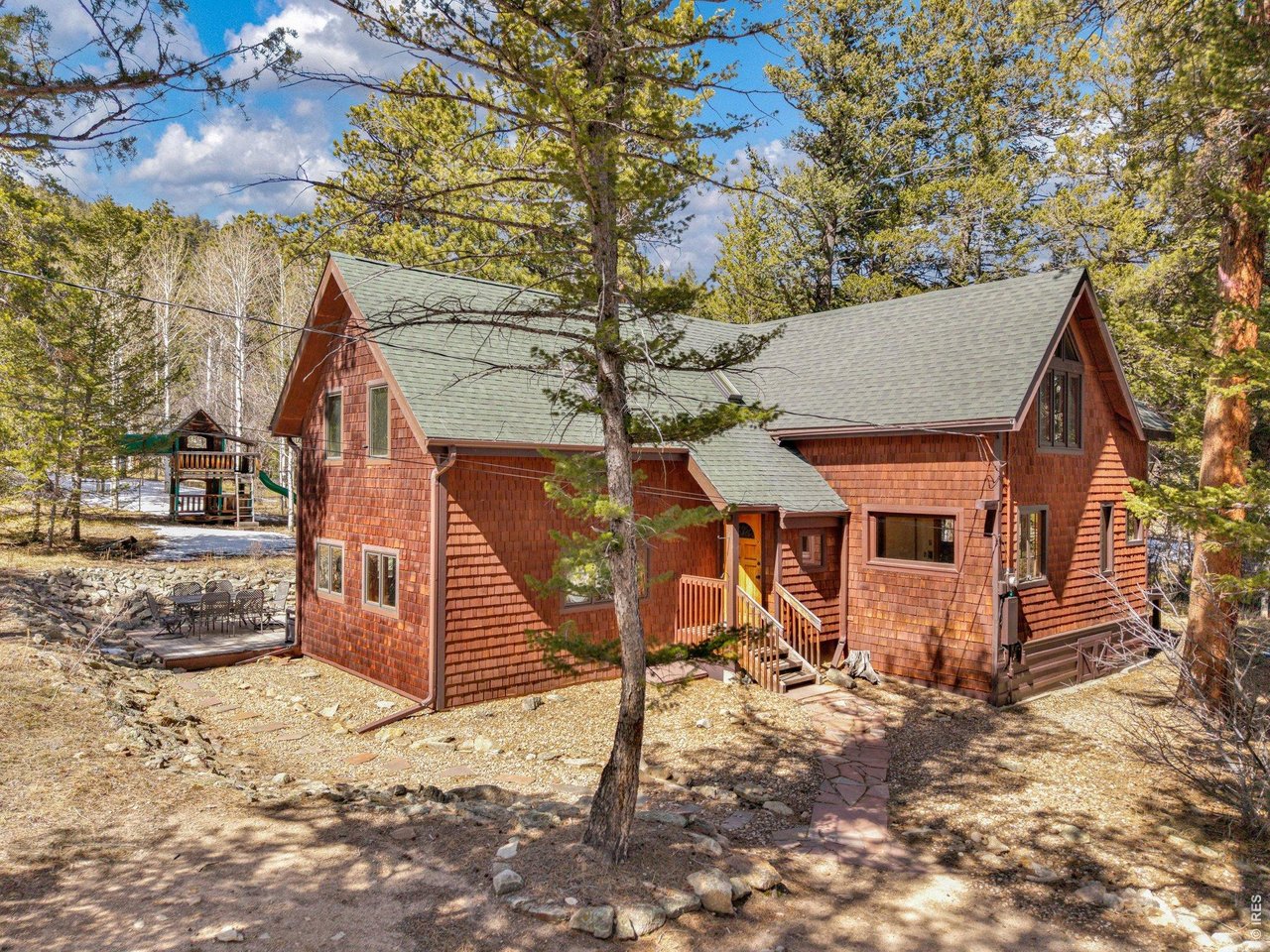 251 Haugen Slide Road Allenspark, CO 80510 - Photo 32 of 42 a view of a house with a yard