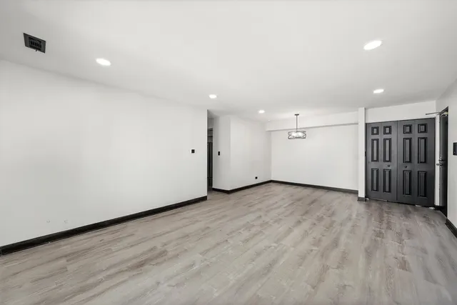 an empty room with wooden floor